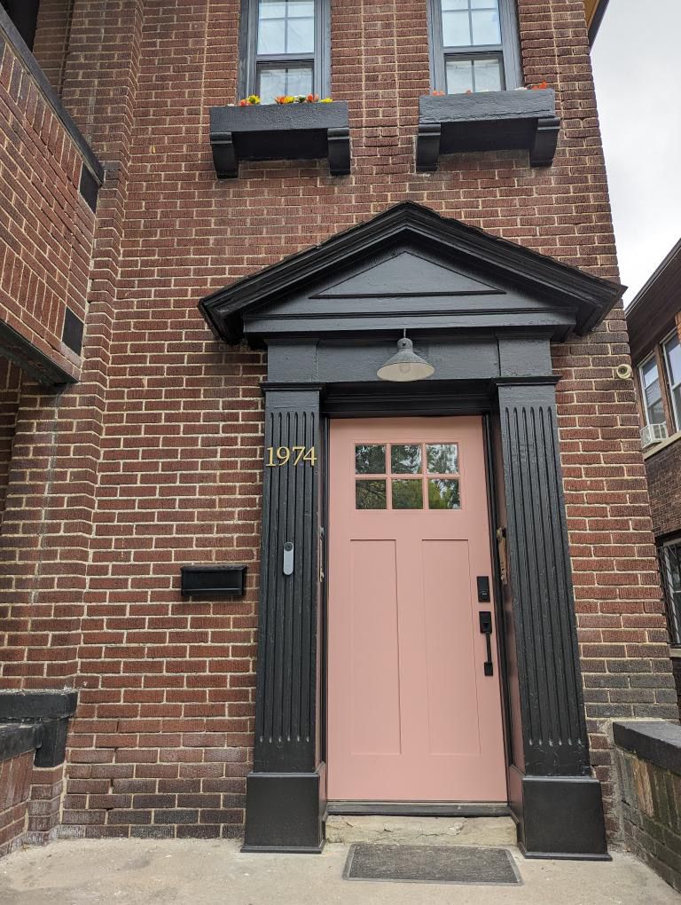 Pink door on a brick house.