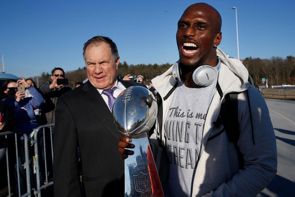 New England Patriots' Jason McCourty laughs after offering the Vince Lombardi Trophy to Patriots head coach Bill Belichick, left, as the Patriots return from Atlanta to Gillette Stadium in Foxborough, MA following their victory over the Los Angeles Rams in Super Bowl LIII on Feb. 4, 2019. 