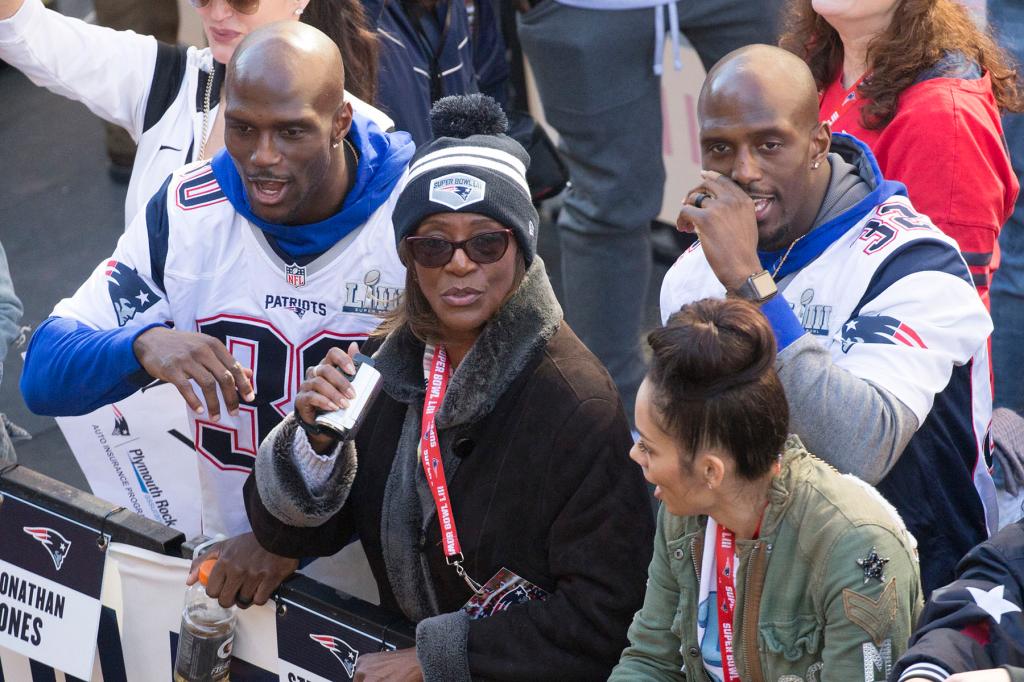 New England Patriots Jason, left, and Devin McCourty are joined by their mother Phyllis Harrell, center, during the New England Patriots Super Bowl LIII rolling rally victory parade on Tuesday, February 5, 2019 in Boston, Massachusetts.