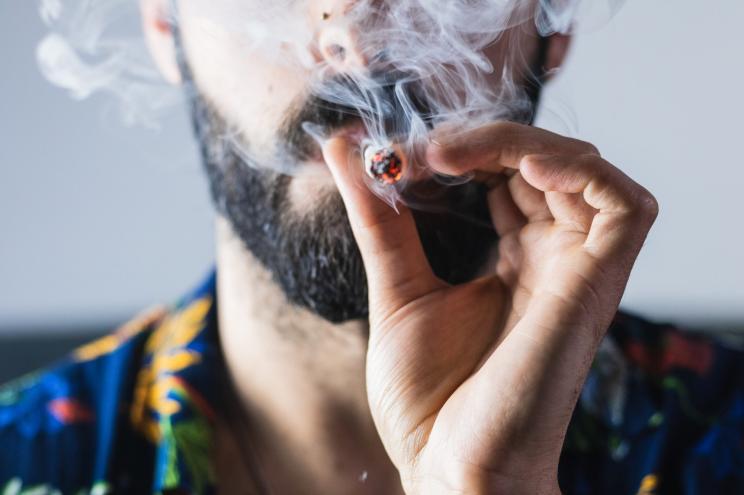 Portrait of anonymous man smoking weed