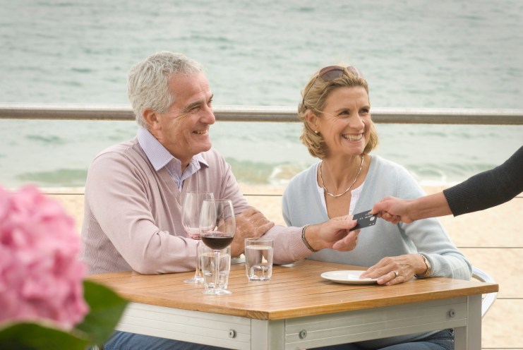 Wealthy couple pays for seaside meal with a credit card