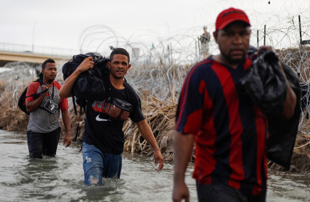 Migrants from Venezuela Danger (L), Richard (C) and Wilder (R) walk along the banks of the Rio Grande river in an attempt to seek asylum into the U. S., as seen from Piedras Negras, Mexico September 30, 2023.