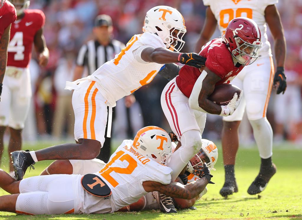 Jase McClellan is tackled as he rushes against Elijah Herring #44, Tamarion McDonald #12 and Aaron Beasley #6 of the Tennessee Volunteers during the second quarter.