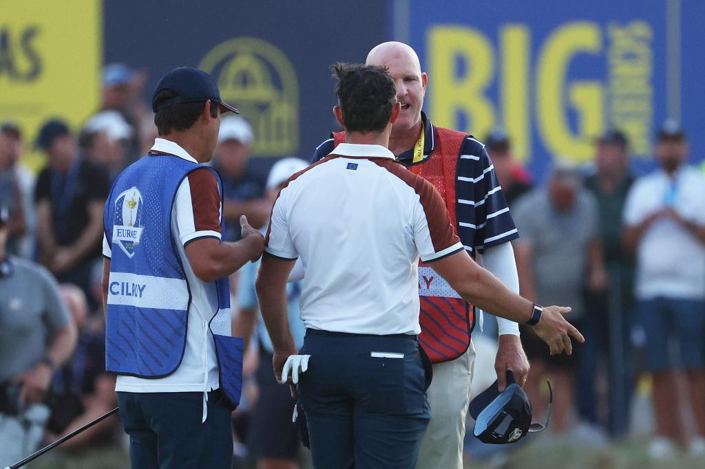 Rory McIlroy and Joe LaCava argue on the green at the Ryder Cup on Sept. 30, 2023.