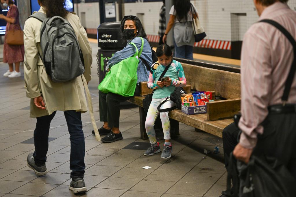 Young girl selling candy on the Columbus Circle B train platform