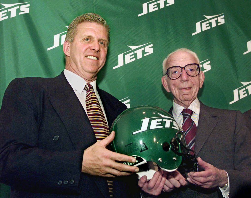 Hess (seen right with Bill Parcells in 1997) built the company into an empire after starting out as a fuel delivery driver with one truck during the Great Depression.