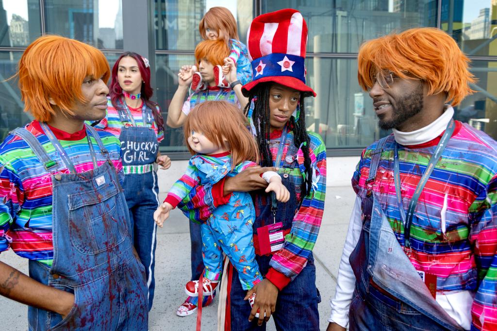 a small group of people dressed in overalls and striped shirts wait to enter the jacob javits center