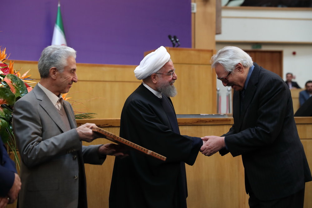 Javad Tabatabai is given an honor by then Iranian president Hassan Rouhani