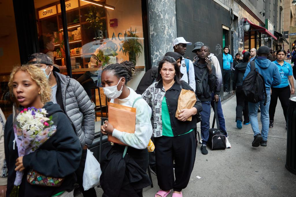 Migrants in line on the street. 