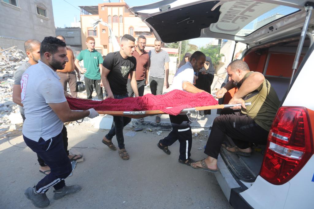 A body being brought into a car in Rafah in the Gaza Strip on October 25, 2023 after an Israeli airstrike.