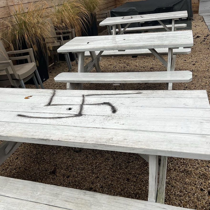 The picnic benches outside Naturally Good were painted with crude swastikas on Sunday night