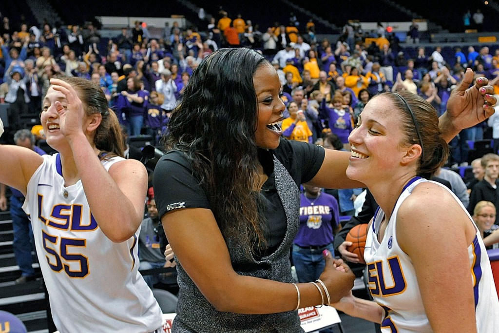 LSU's Theresa Plaisance (55) walks past then-LSU assistant coach Tasha Butts as she celebrates the team's win over Kentucky with guard Jeanne Kenney after an NCAA college basketball game in Baton Rouge, La., Feb. 24, 2013. Georgetown women's basketball coach Tasha Butts died Monday, Oct. 23, 2023, after a two-year battle with breast cancer. The 41-year-old coach was diagnosed with advanced stage breast cancer in 2021.