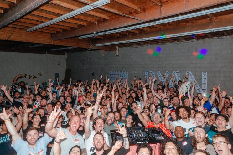 A group shot is shown of several individuals name Ryan cheering at a party.