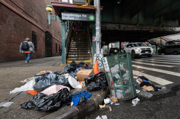 Trash on the sidewalk in front of the Kingsbridge station