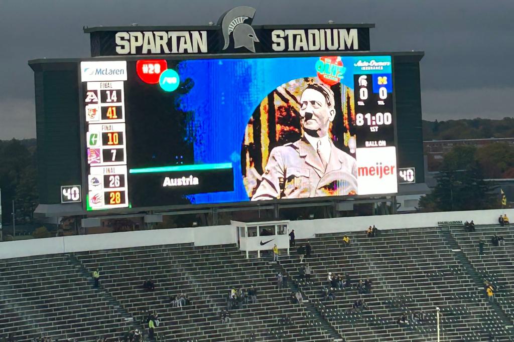 Michigan State claims the school used a third-party source that displayed the Hitler image on the video board, saying the photo was part of a pregame quiz. 