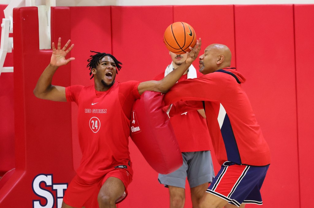 Zuby Ejiofor works on his post-up game with the St. John's coaching staff.