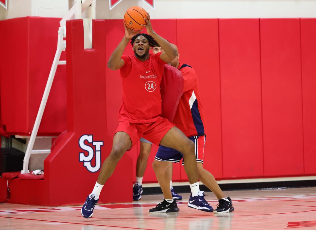 Zuby Ejiofor works on his post-up game with the St. John's coaching staff.