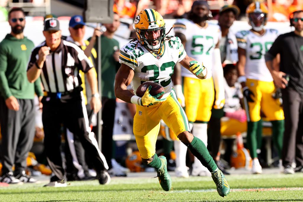 Aaron Jones #33 of the Green Bay Packers carries the ball against the Denver Broncos during the second half of the game at Empower Field At Mile High on October 22, 2023 in Denver, Colorado. 