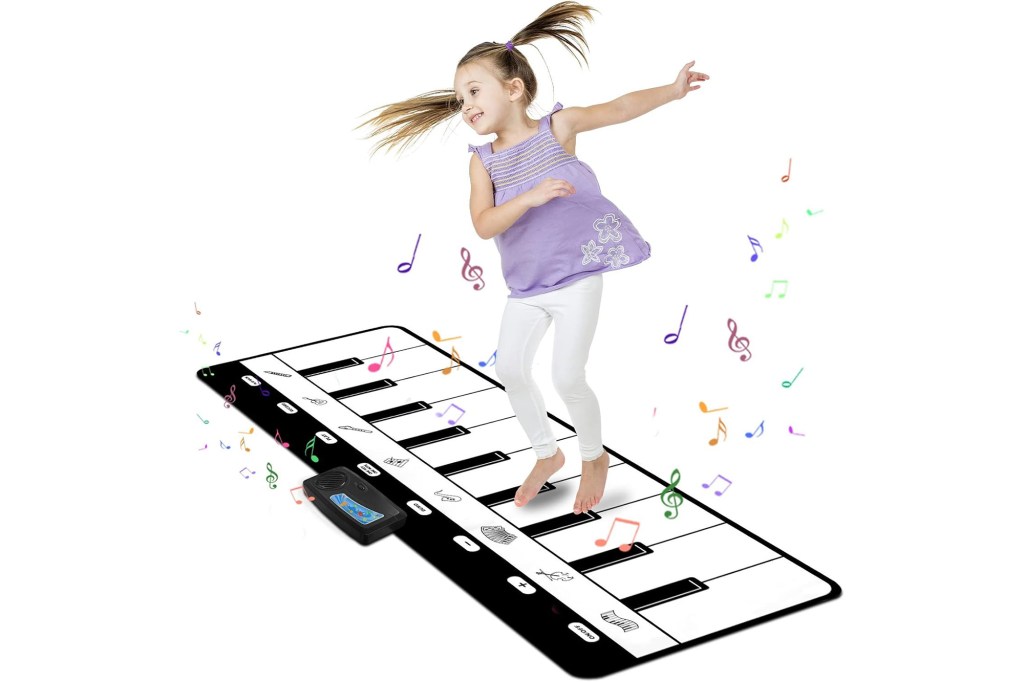 Girl playing on piano mat