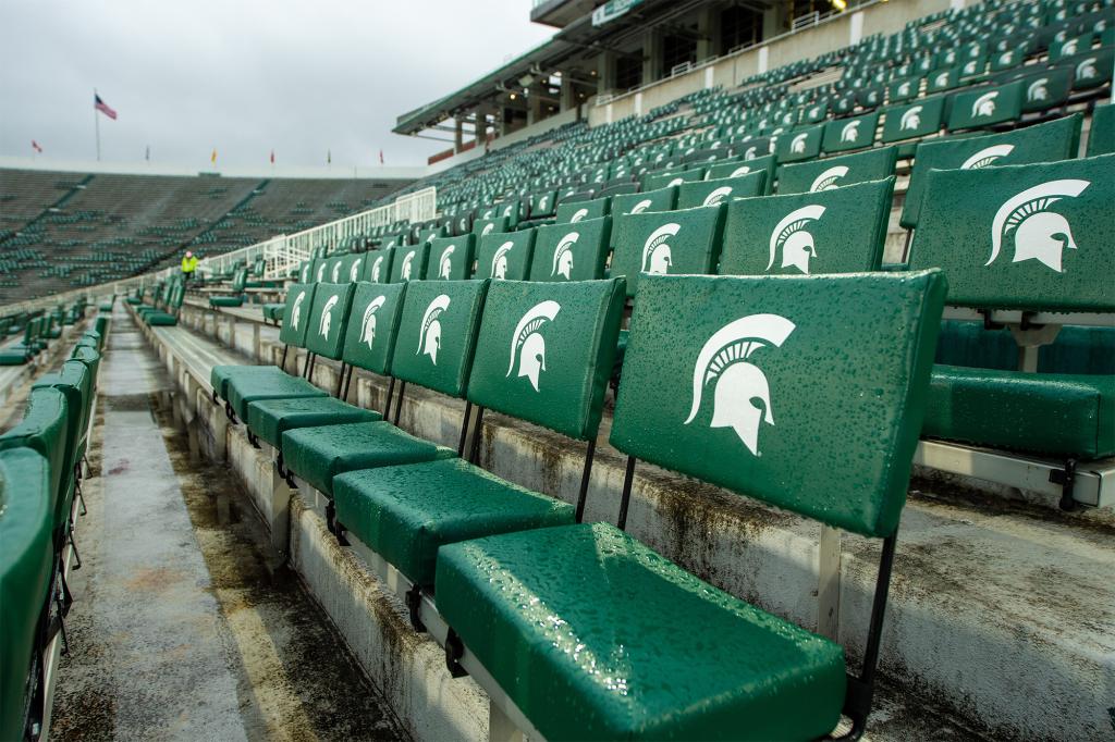 Michigan State suspended an employee with pay after a photo of Adolf Hitler was shown on its scoreboard before a game Saturday.