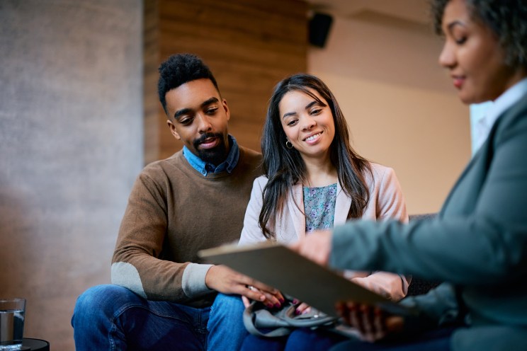 Couple opens a high-interest saving account at the bank.