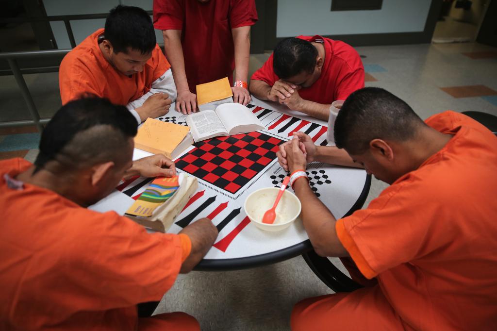 Immigrant detainees pray during a prayer group in a general population block at the Adelanto Detention Facility on November 15, 2013.