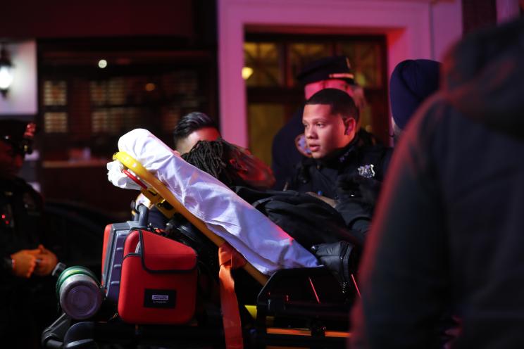 The victim is shown being taken away in an ambulance on Oct. 31, 2023 in New York, New York.