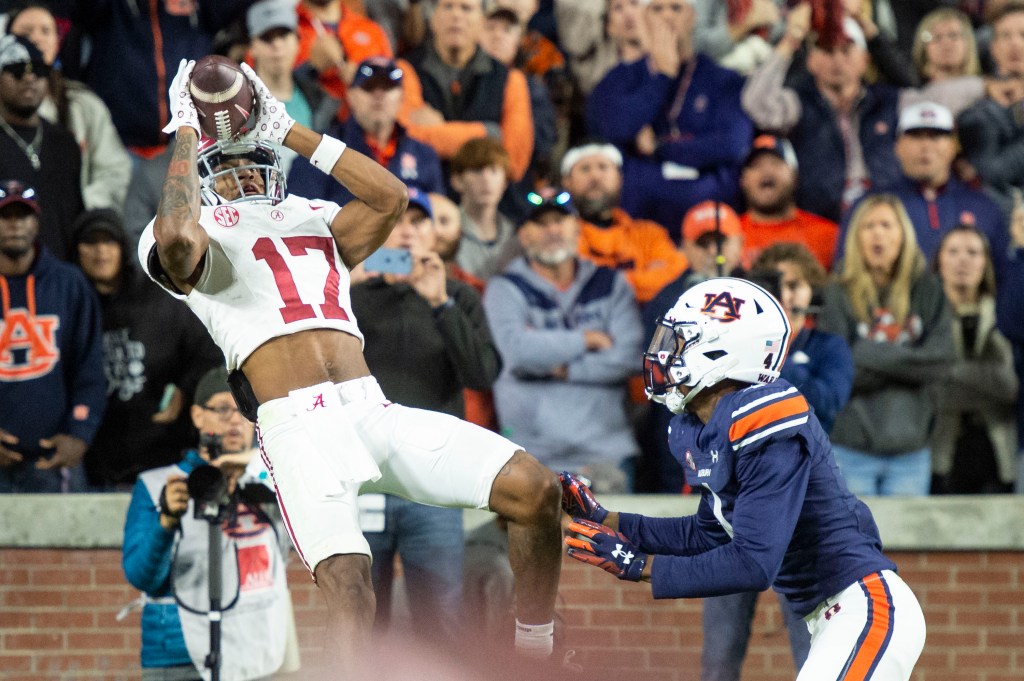 Wide receiver Isaiah Bond catches a pass for a touchdown in front of cornerback D.J. James in the final minute of the Iron Bowl game.