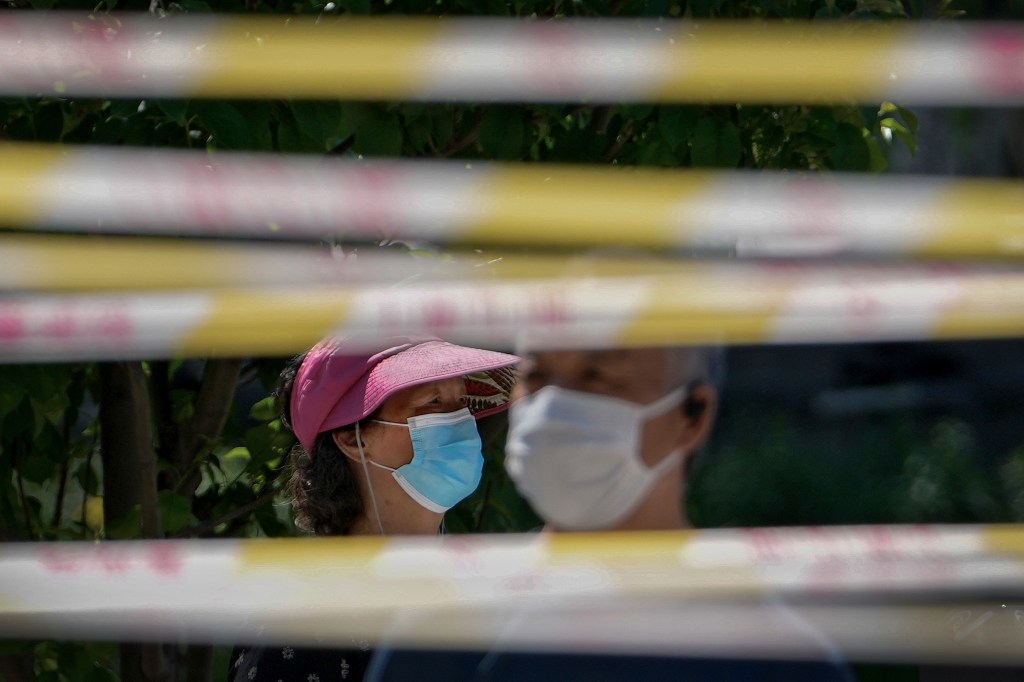 Chinese people wear face masks.