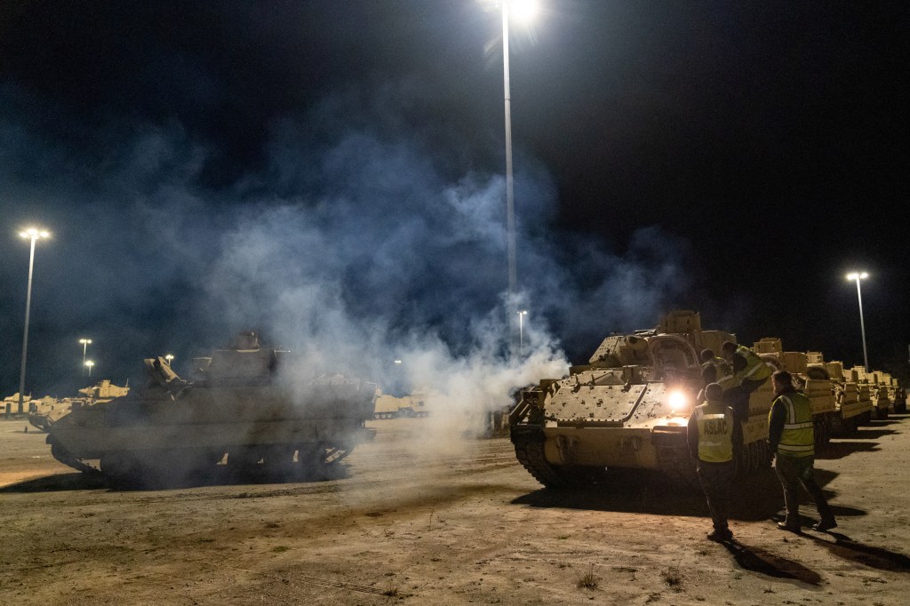 Stevedore drivers work through the night to load a Ukraine-bound convoy of Bradley Fighting Vehicles load onto the carrier ARC Integrity at the Transportation Core Dock in North Charleston, South Carolina, U.S. January 25, 2023.