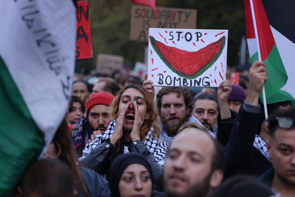 Ant-Israel protesters hold up watermelon signs.