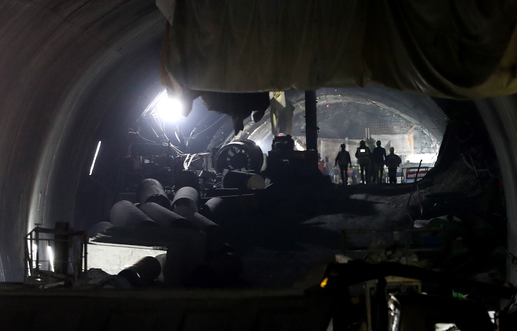 Rescue workers at the site of a tunnel collapse on the Brahmakal Yamunotri National Highway