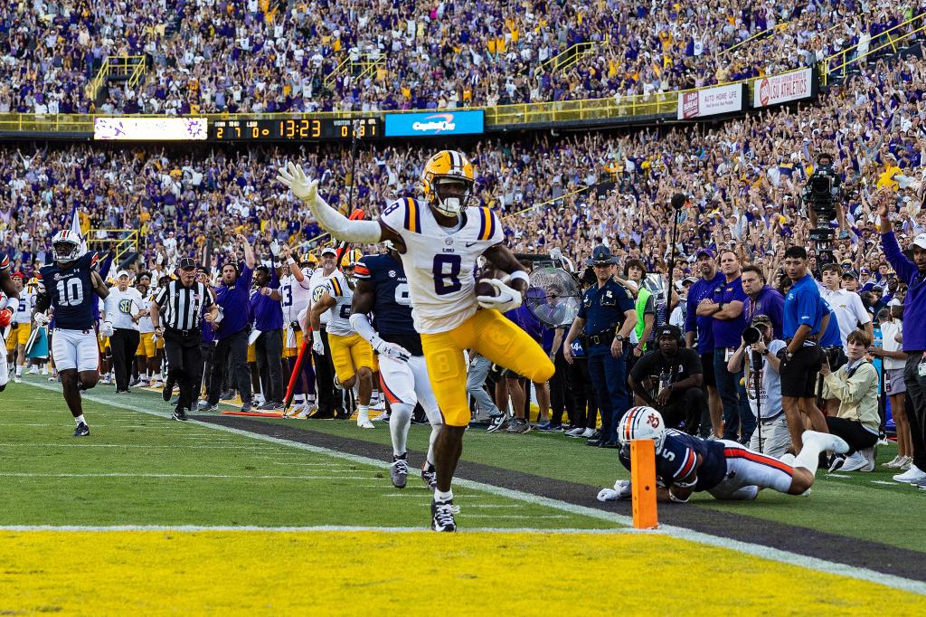 LSU Tigers wide receiver Malik Nabers (8) scores a touchdown during a game between the LSU Tigers and the Auburn Tigers on October 14, 2023, at Tiger Stadium in Baton Rouge, Louisiana. 