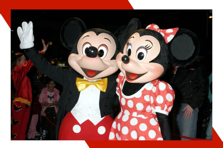 Mickey (L) and Minnie wave to the camera.