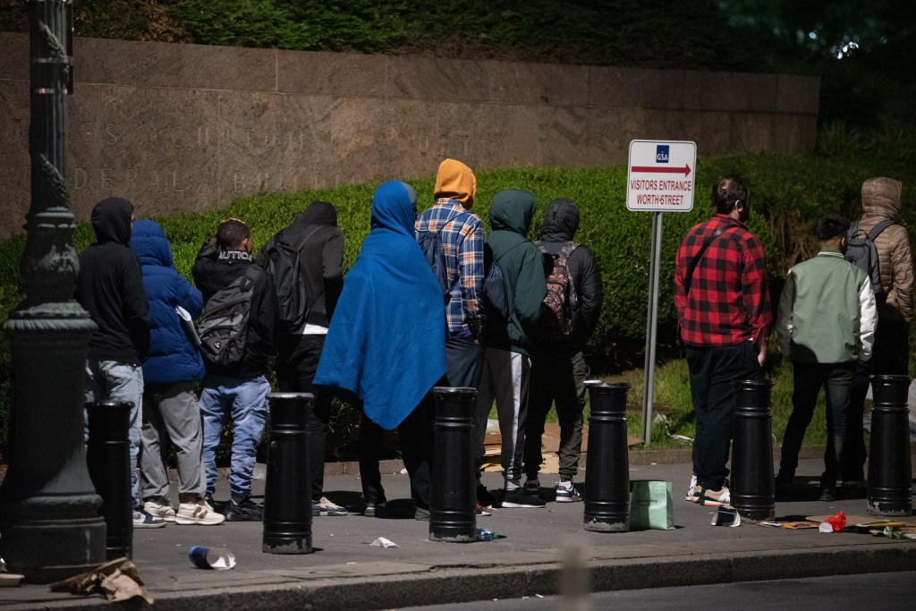 Migrants wait at the front of the line at 26 Federal Plaza to apply for federal services, such as a work permit or asylum. 