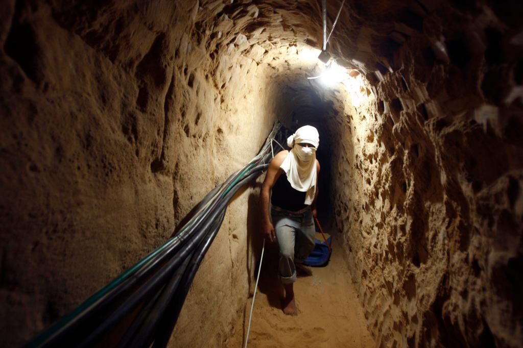 A Palestinian walks in a smuggling tunnel while repairing it in Rafah near Gaza's border with Egypt January 22, 2009.