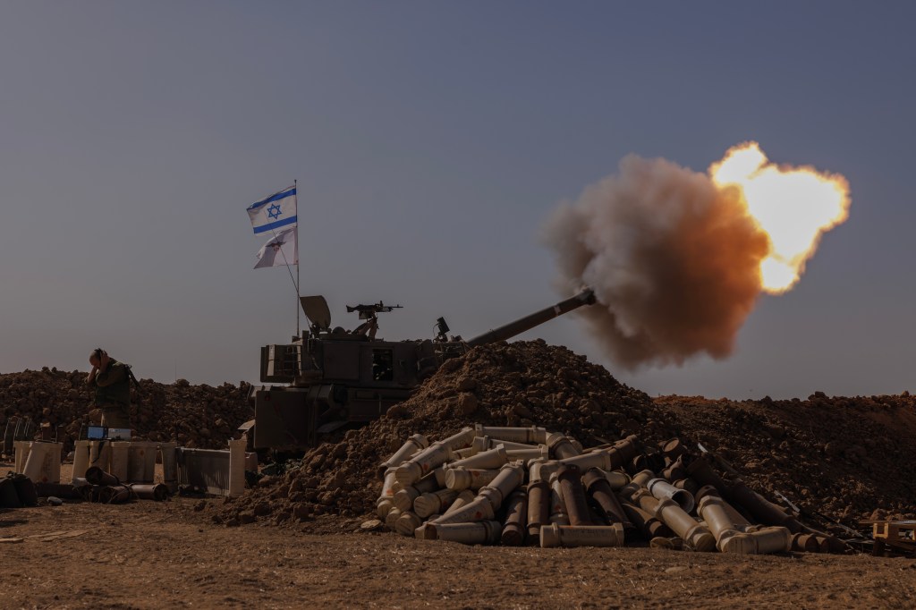 An Israeli artillery unit fires from the Israeli side of the border towards the Gaza Strip