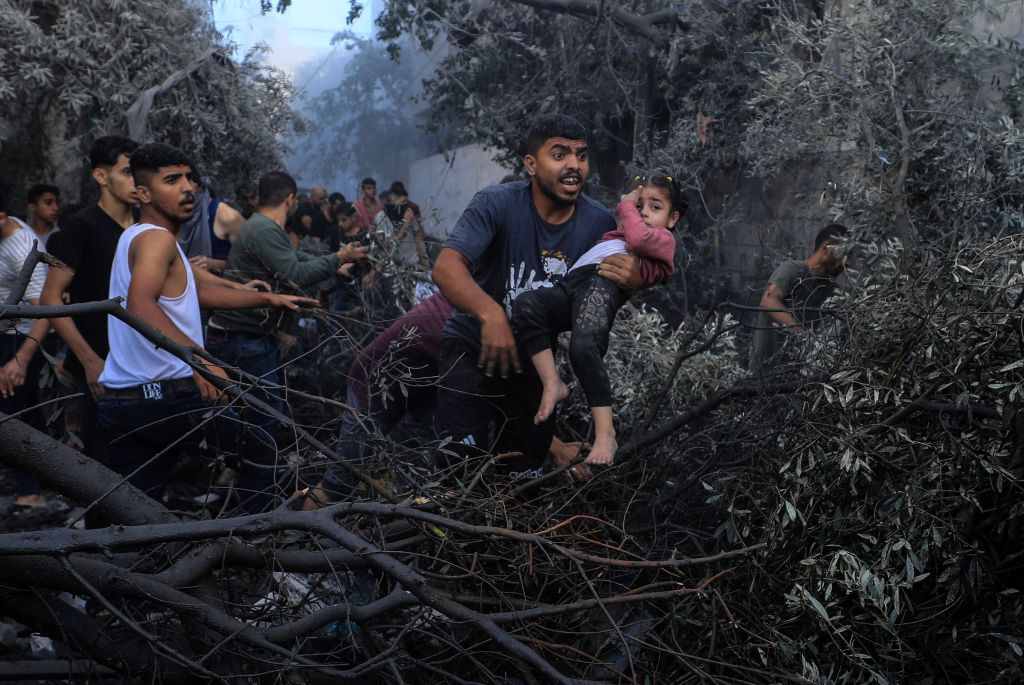 People escape after the Israeli strike at a refugee camp in central Gaza.