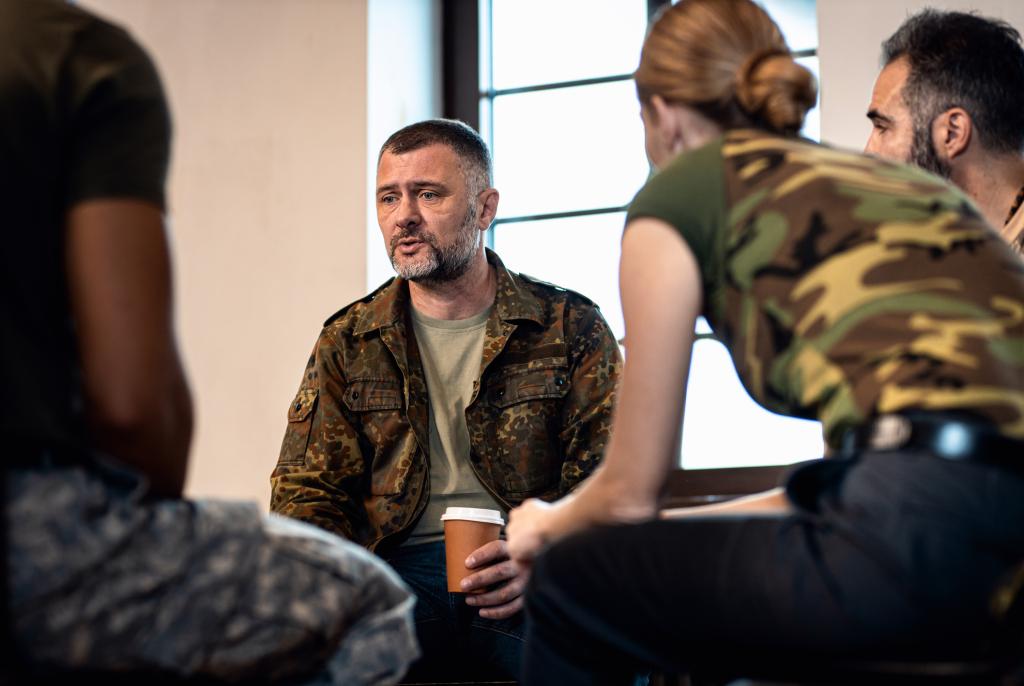 Group of veterans talking during PTSD support group.