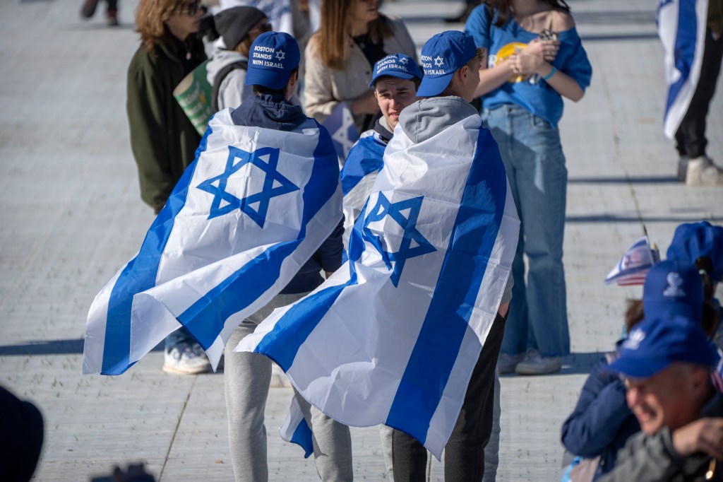 Israeli supporters drape themselves in Israel's flag for the march.