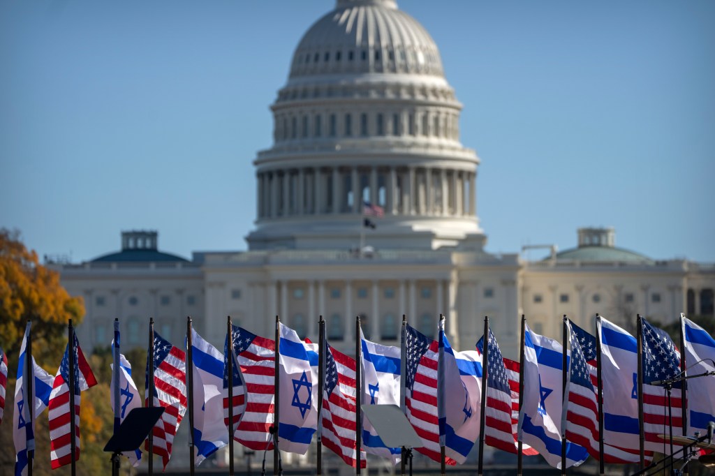 US and Israeli flags fly on the stage at the massive march.