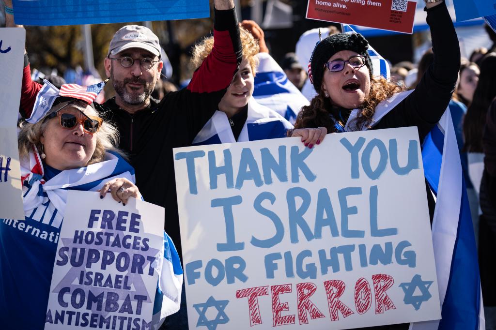 Backers of Israel's war on Hamas tote signs in support to Tuesday's rally.