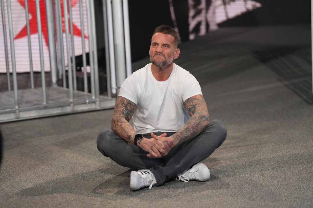 CM Punk reacts as he makes his return to WWE on Saturday.