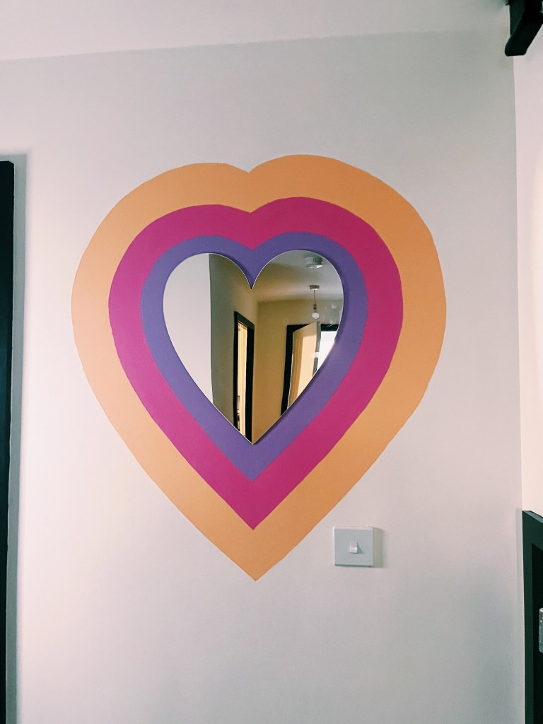 The rainbow heart mirror in the hallway in Jemma Murphy's house.