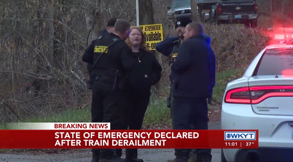 Police are spotted at the scene where a train derailed in Livingston and spilled chemicals that caught on fire. 