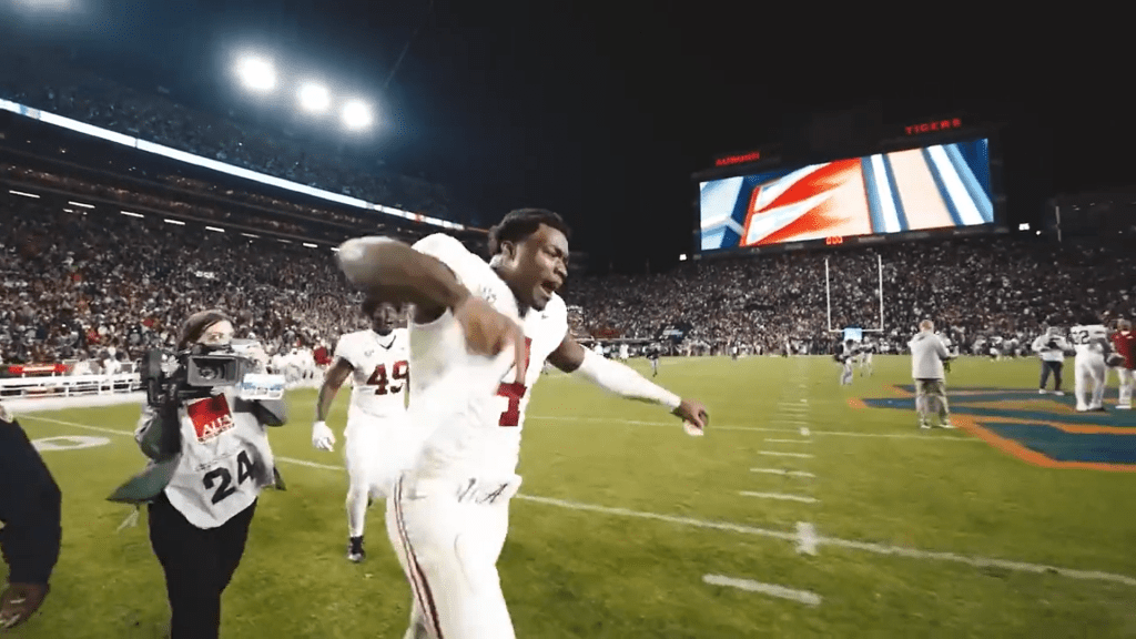 Jalen Milroe in celebration, yelling a NSFW message, after grabbing the Iron Bowl win over Auburn.