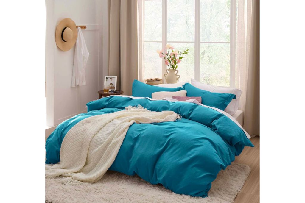 A bed with blue bedding.