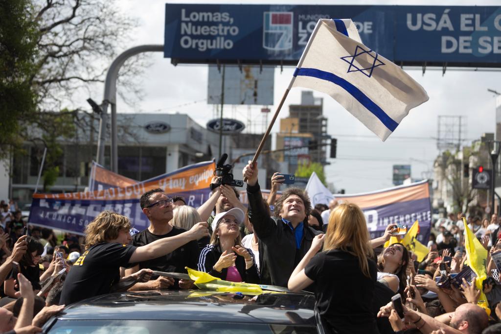 Argentina's new president Javier Mileai waving an Israeli flag