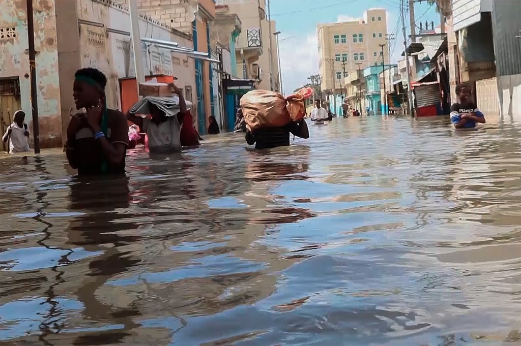 Residents were seen moving through floodwaters on a street in the town of Beledweyne, in Somalia on, Nov. 19, 2023.