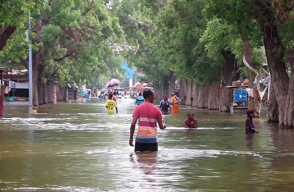 Residents were seen moving through floodwaters on a street in the town of Beledweyne, in Somalia on, Nov. 19, 2023.